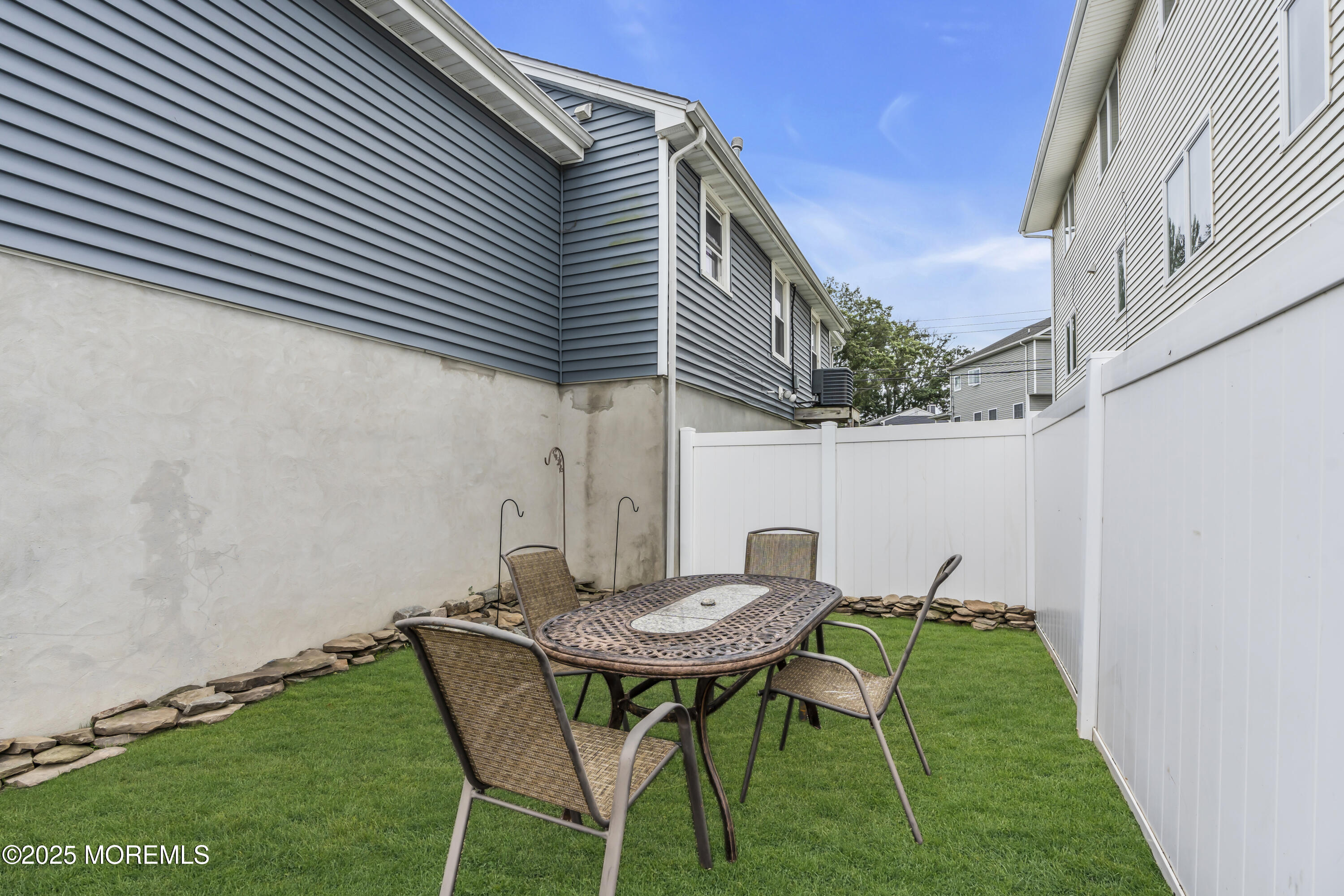 825 Lorillard Avenue Union Beach, NJ 07735 - Photo 20 of 22 a backyard of a house with table and chairs
