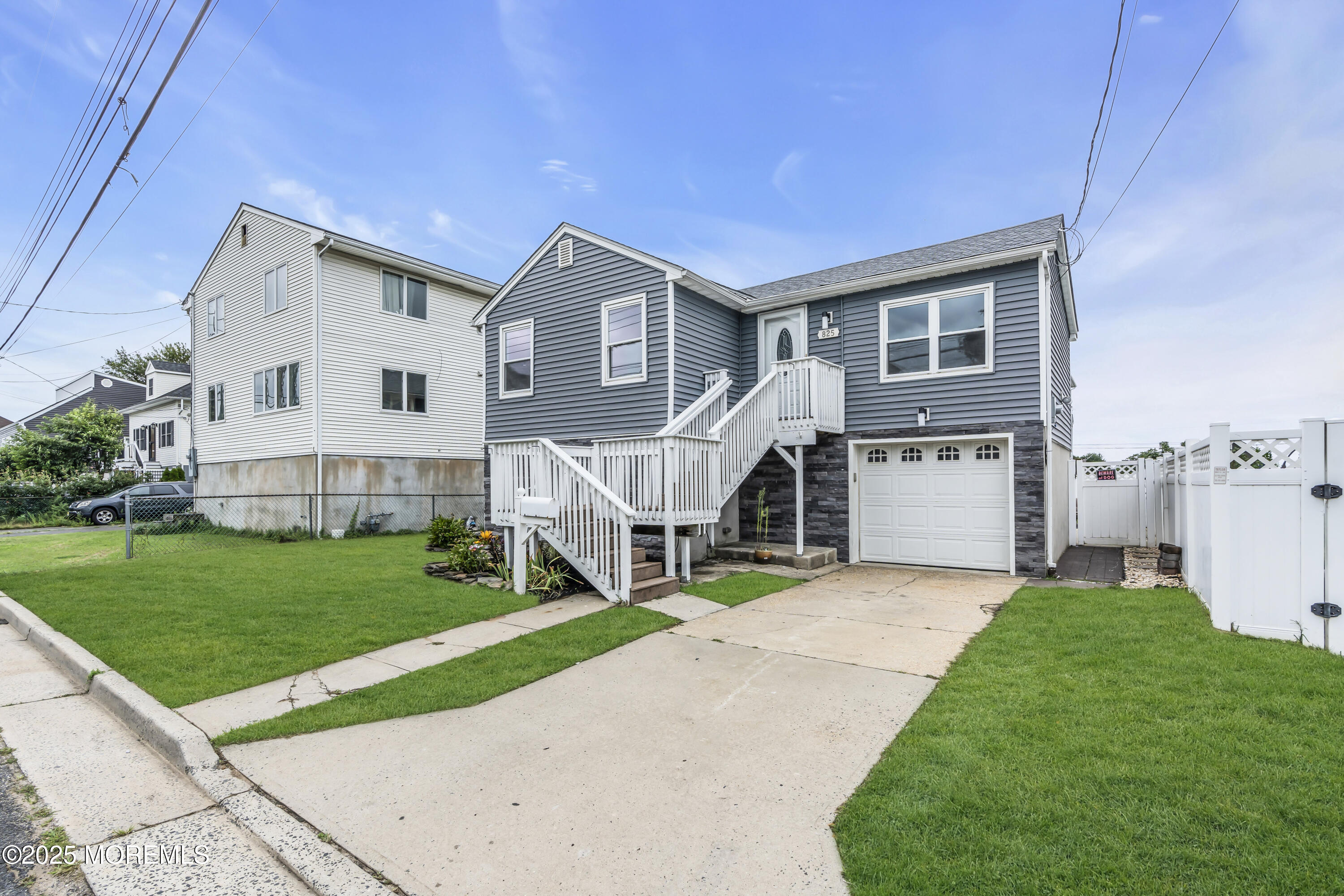 825 Lorillard Avenue Union Beach, NJ 07735 - Photo 2 of 22 a front view of a house with a yard and garage