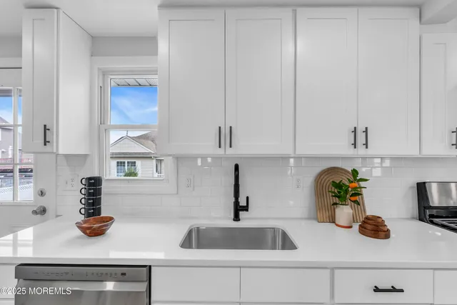 a kitchen with a sink and cabinets