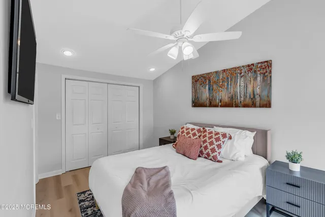 a bedroom with a large bed and a chandelier