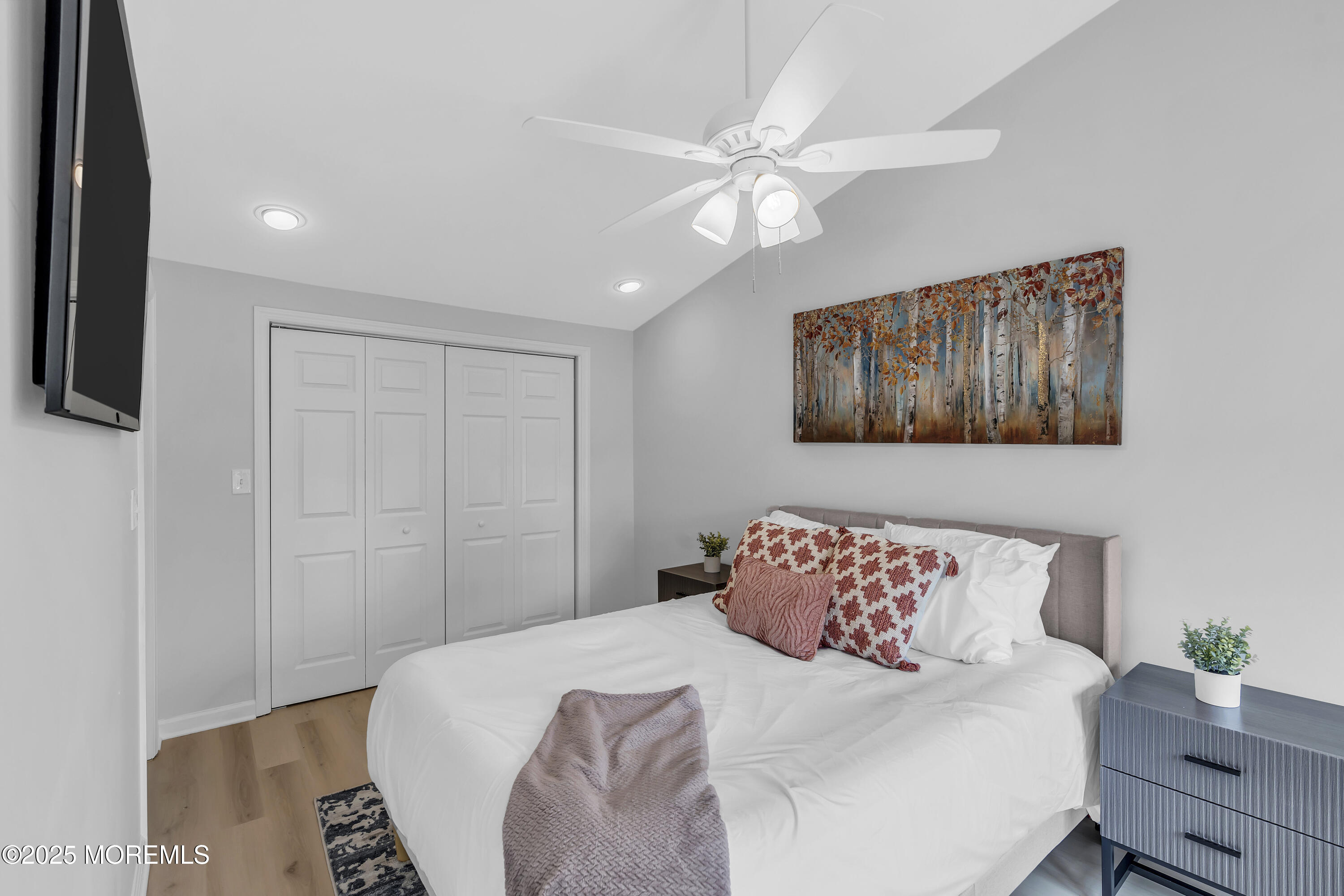 825 Lorillard Avenue Union Beach, NJ 07735 - Photo 9 of 22 a bedroom with a large bed and a chandelier