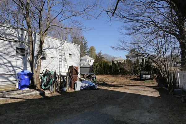 a view of a backyard with wooden fence