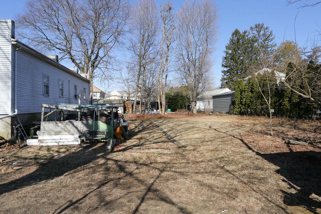 62 Waltham Street Maynard, MA 01754 - Photo 5 of 8 a view of a backyard with wooden fence