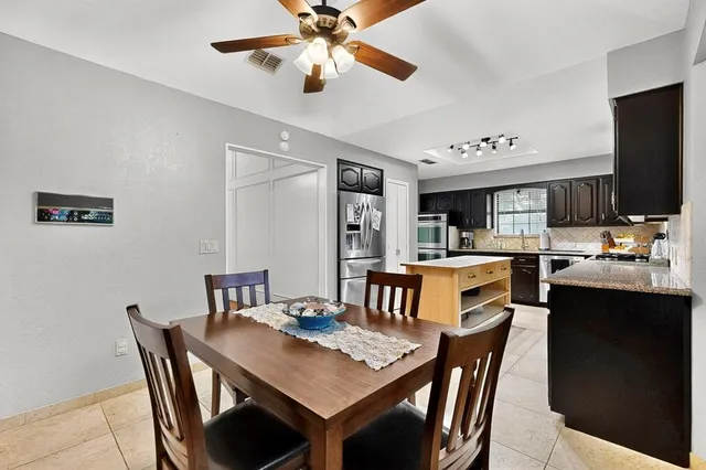 a kitchen with stainless steel appliances granite countertop a sink stove and microwave
