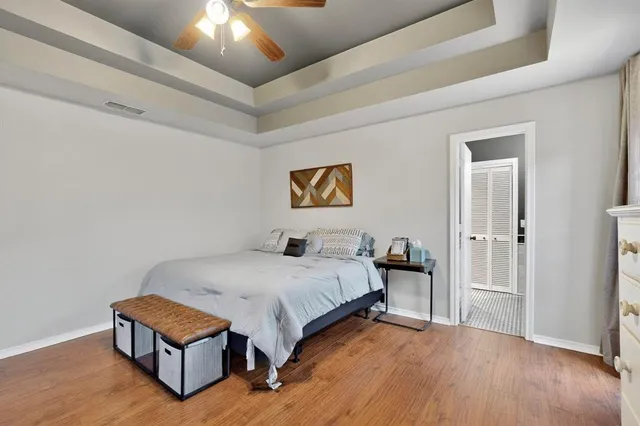 a bedroom with bed and wooden floor