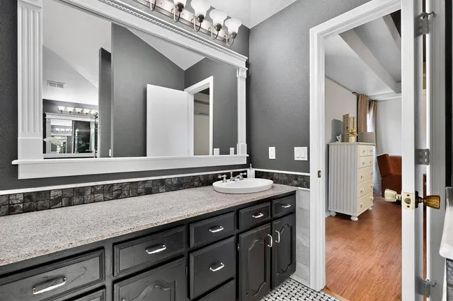 a room with a bed and a chandelier