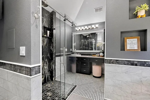 a bathroom with a bathtub and a shower