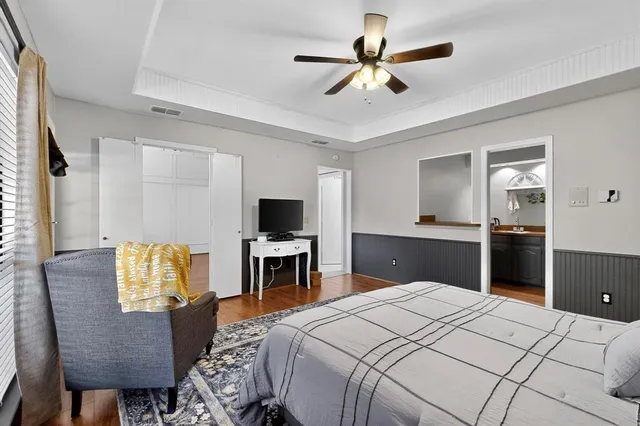 a bedroom with a bed and wooden floor