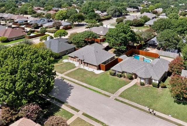 an aerial view of a house with a yard