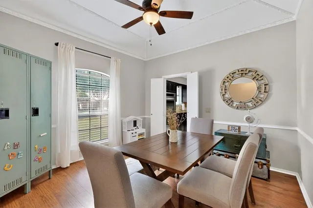 a view of a dining room with furniture and wooden floor