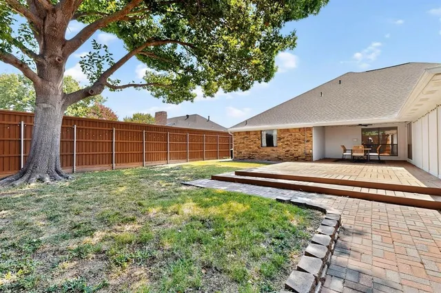 a view of a house with backyard and sitting area