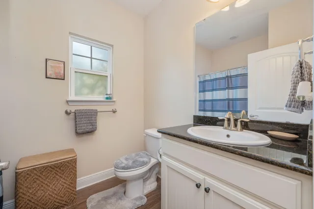 a bathroom with a toilet a sink and mirror