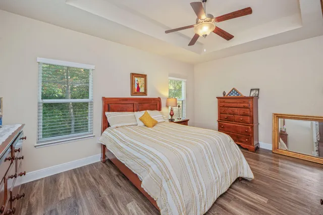 a bedroom with a bed and a window with balcony view