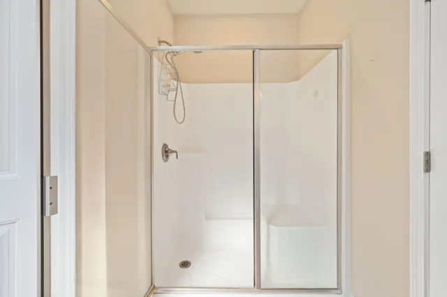 a bathroom with a glass shower door