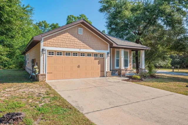 a view of backyard of house and garage