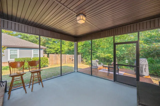 a view of pool with a table and chairs