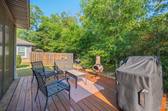 a backyard of a house with wooden floor yard barbeque oven and outdoor seating
