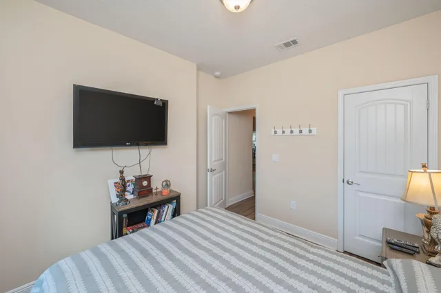 a view of room with wooden floor and flat screen tv