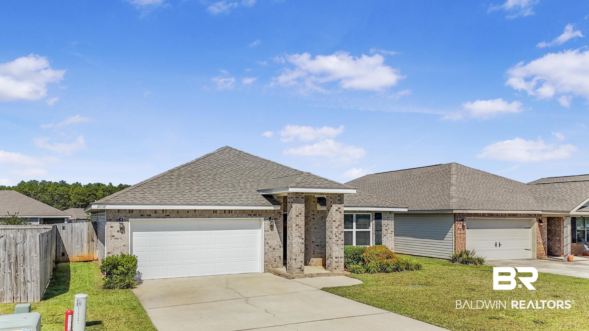 10738 Ridgeview Drive Mobile, AL 36608 - Photo 32 of 48 Single story home featuring a shingled roof, brick siding, driveway, and an attached garage