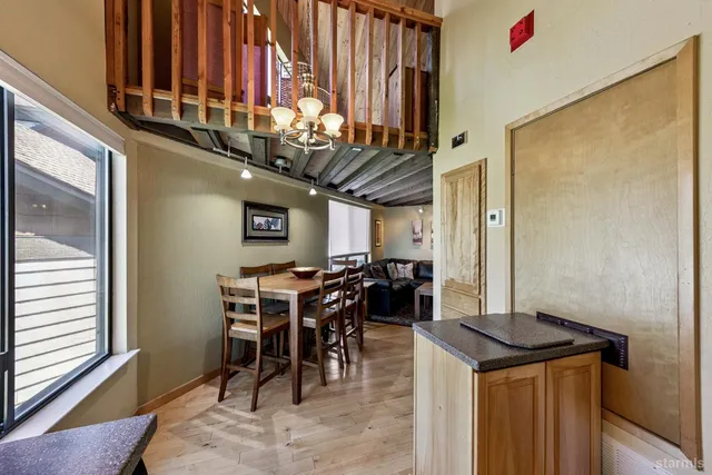 a view of a dining area with furniture and chandelier