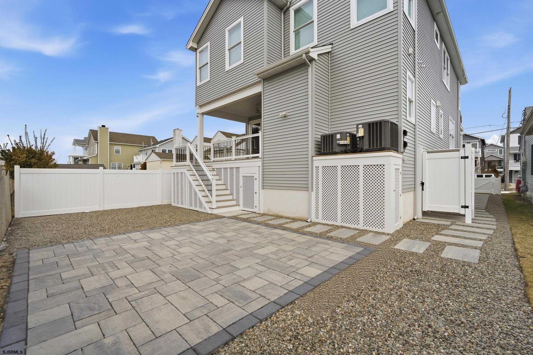 150 South 9th Brigantine, NJ 08203 - Photo 19 of 32 a view of a house with a barbeque and wooden fence