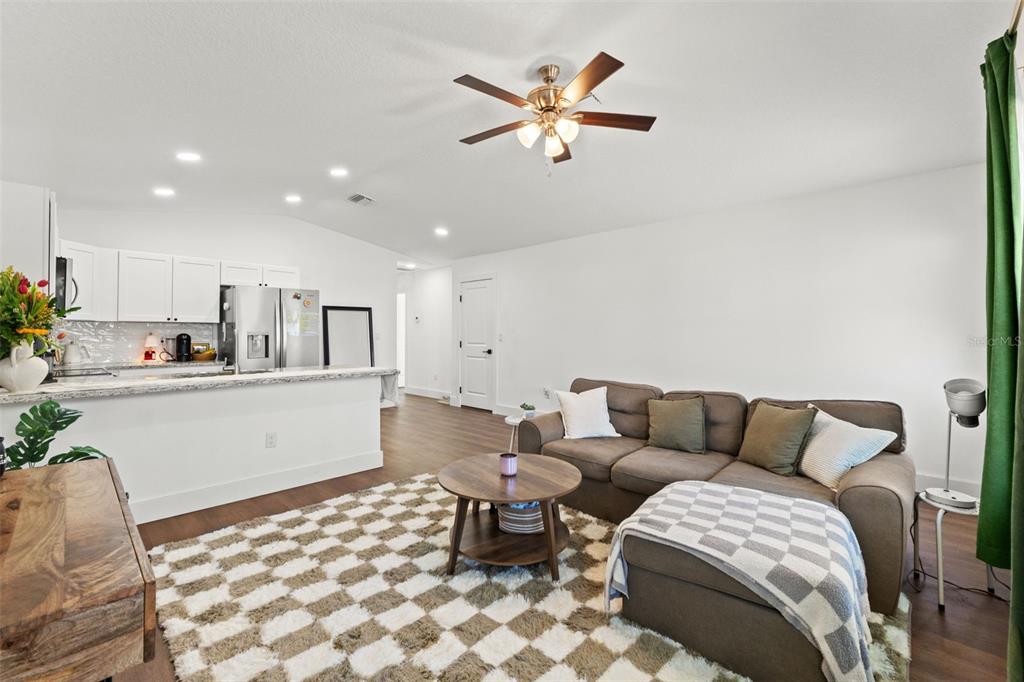 3592 Arrowhead Avenue Spring Hill, FL 34606 - Photo 6 of 22 a living room with a couch and a view of kitchen