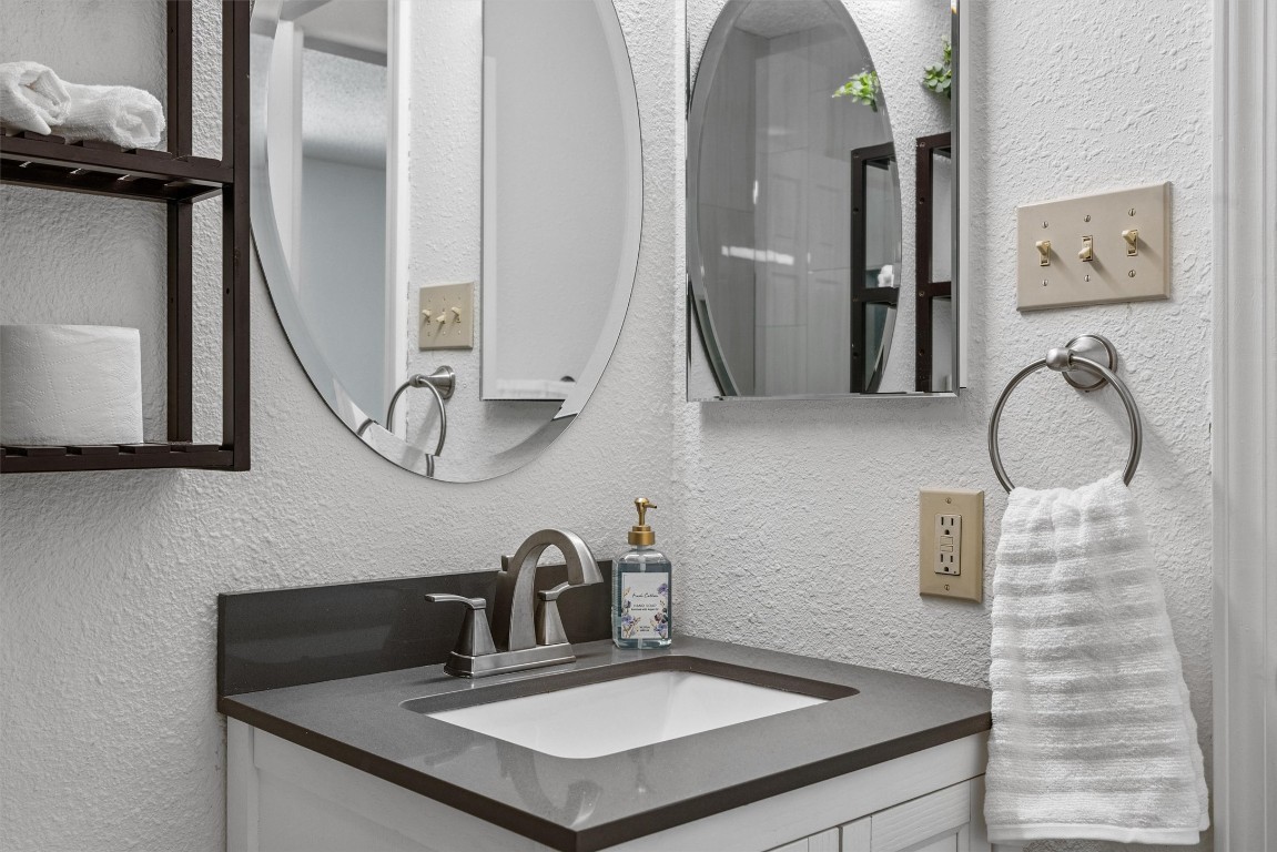 6308 Shadow Bend Austin, TX 78745 - Photo 14 of 35 a bathroom with a sink and a mirror