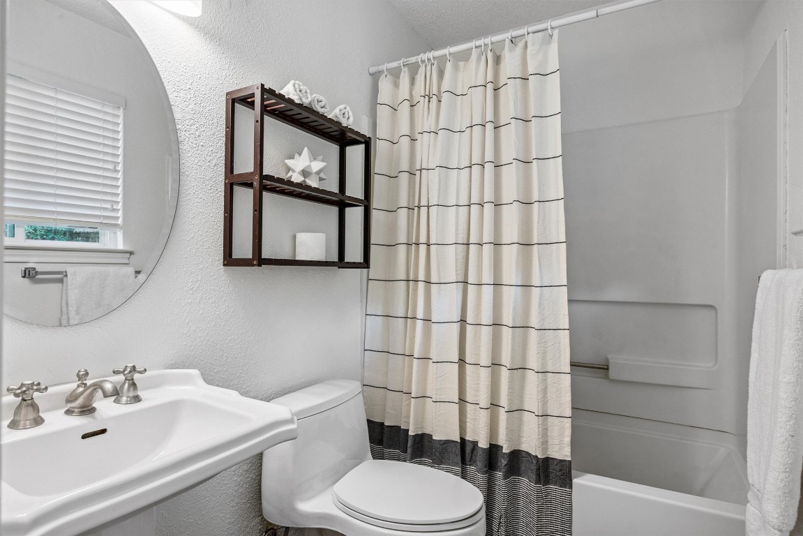 6308 Shadow Bend Austin, TX 78745 - Photo 18 of 35 a bathroom with a sink toilet and shower