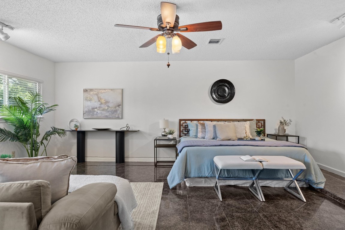 6308 Shadow Bend Austin, TX 78745 - Photo 19 of 35 a bedroom with furniture and a bed