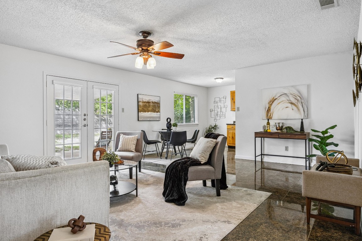 6308 Shadow Bend Austin, TX 78745 - Photo 2 of 35 a living room with furniture a chandelier and a window