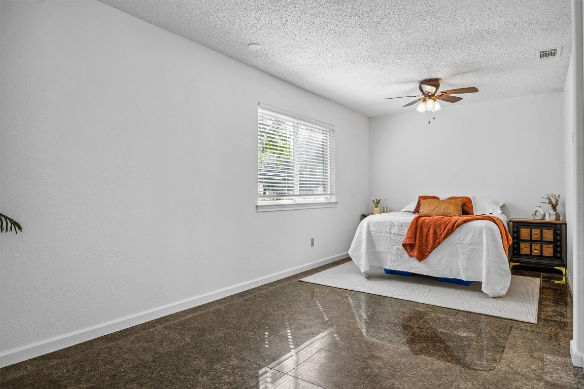 6308 Shadow Bend Austin, TX 78745 - Photo 10 of 35 a bedroom with a bed and wooden floor