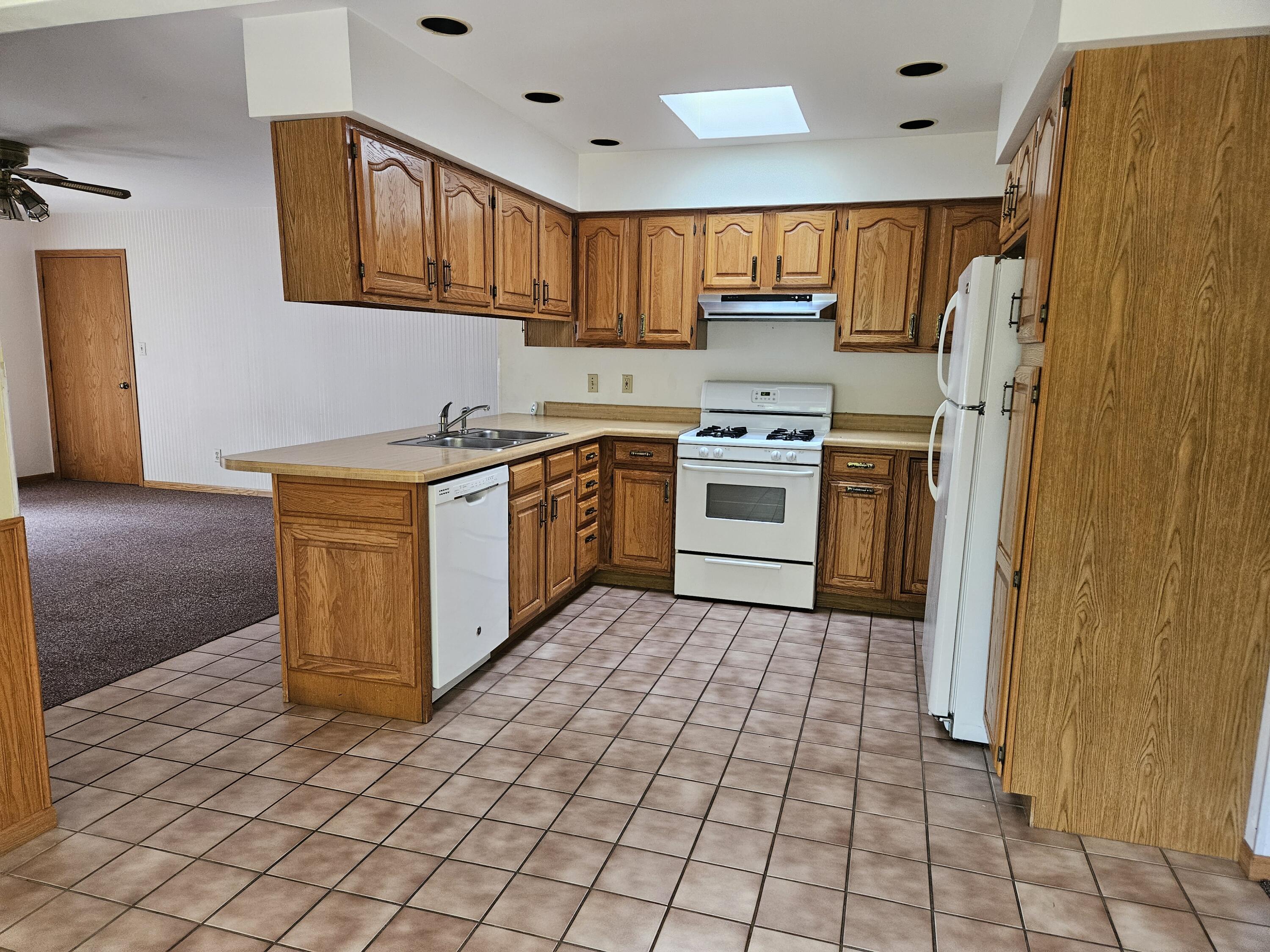 680 Meadow Lane Crown Point, IN 46307 - Photo 12 of 46 a kitchen with stainless steel appliances granite countertop a stove a sink dishwasher and a refrigerator