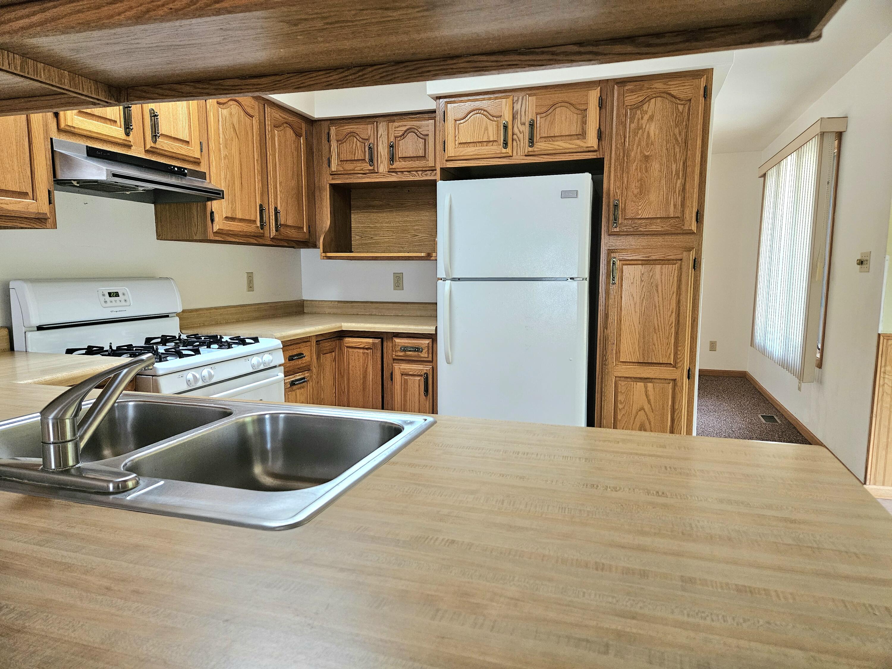 680 Meadow Lane Crown Point, IN 46307 - Photo 13 of 46 a kitchen with stainless steel appliances granite countertop a sink and a refrigerator