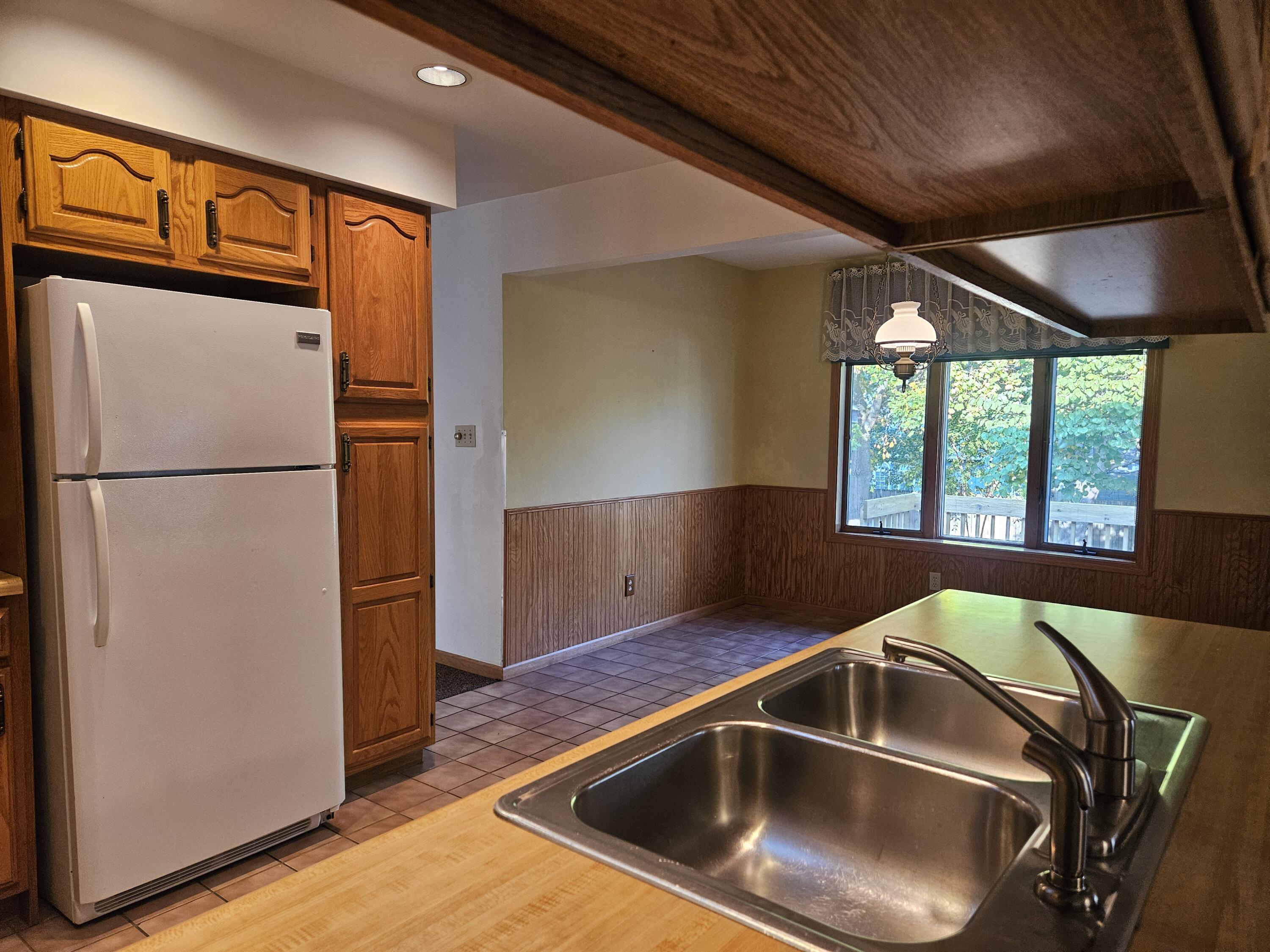 680 Meadow Lane Crown Point, IN 46307 - Photo 15 of 46 a kitchen with a sink and a refrigerator