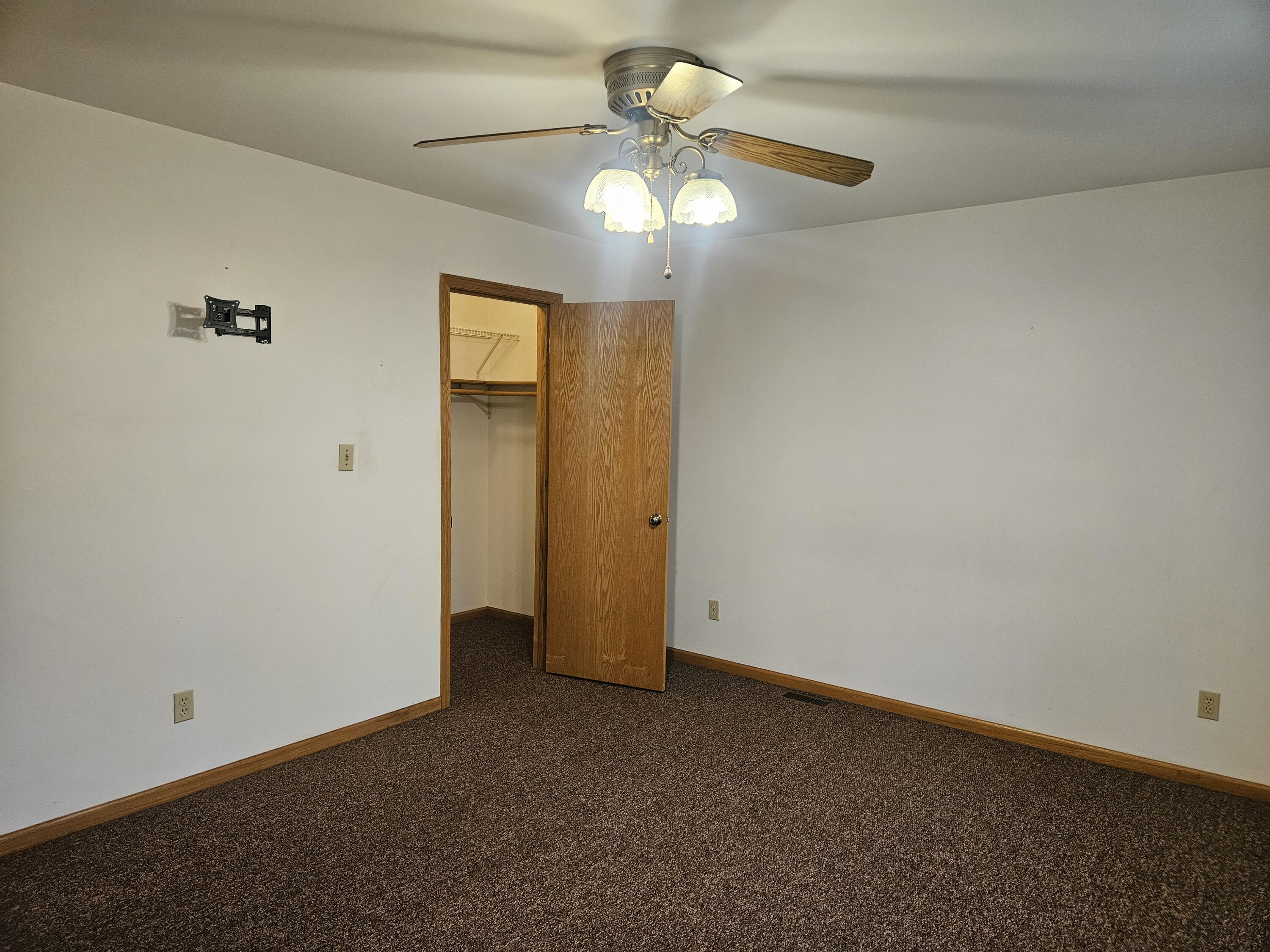 680 Meadow Lane Crown Point, IN 46307 - Photo 20 of 46 an empty room with a chandelier fan and a chandelier fan