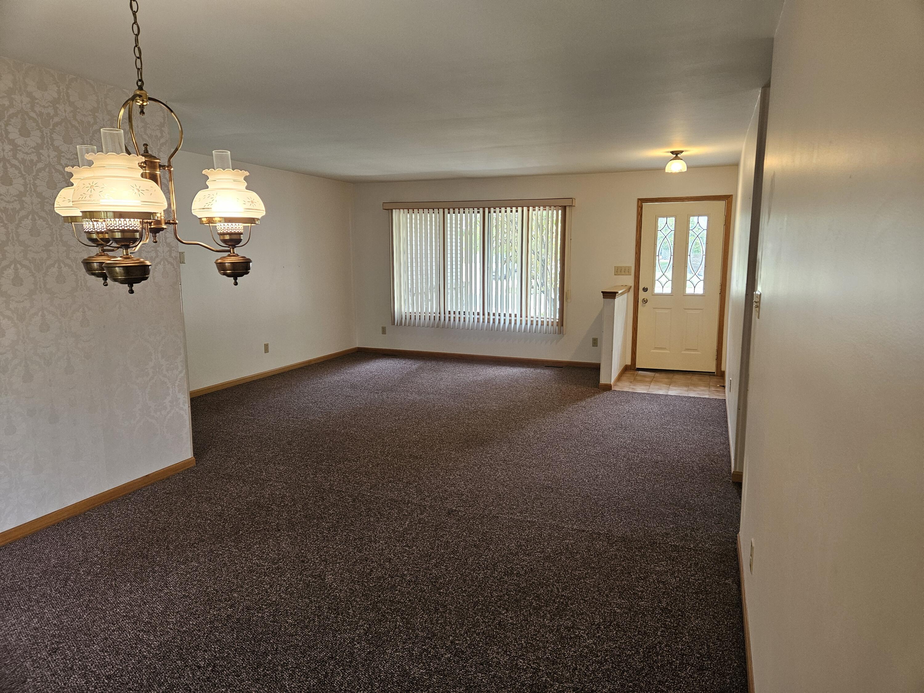 680 Meadow Lane Crown Point, IN 46307 - Photo 4 of 46 a view of a room with a chandelier fan and windows