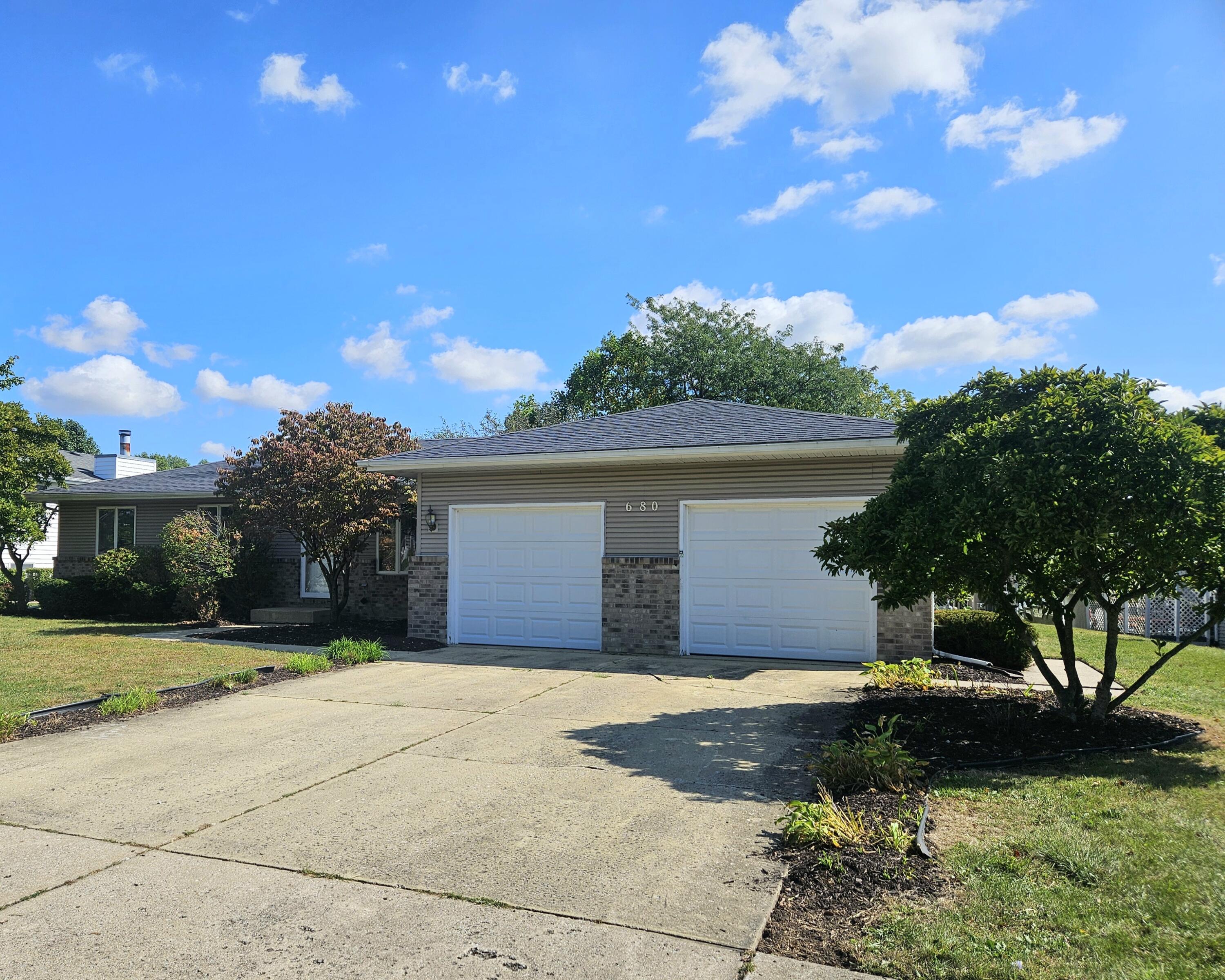 680 Meadow Lane Crown Point, IN 46307 - Photo 46 of 46 a front view of a house with a yard and garage
