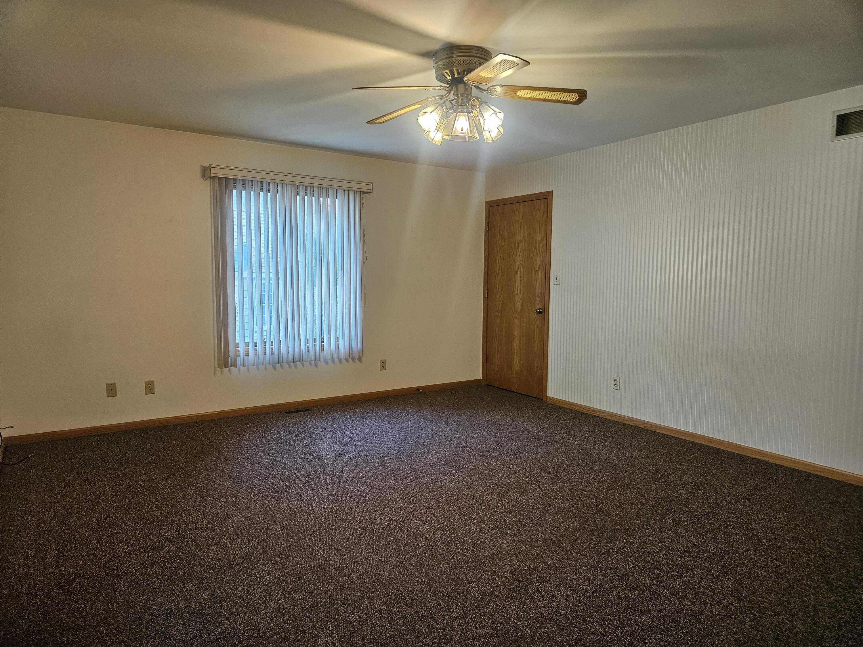 680 Meadow Lane Crown Point, IN 46307 - Photo 9 of 46 an empty room with windows and fan