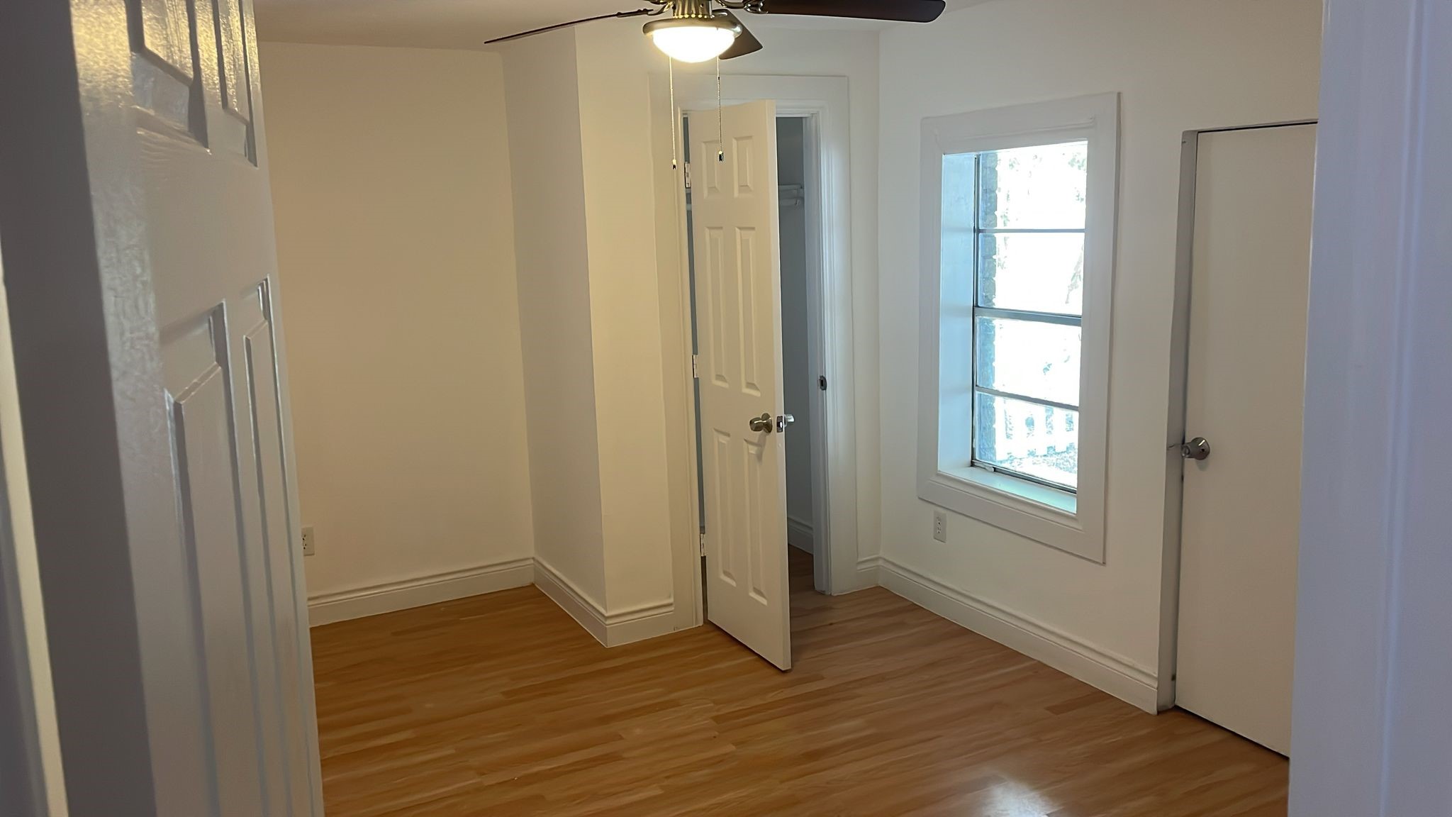 3518 Schurmier Road, Unit A Houston, TX 77047 - Photo 7 of 12 a view of an empty room with wooden floor and a window