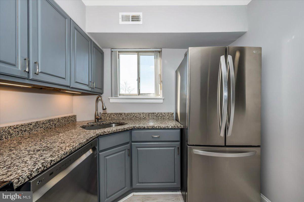 11368 Cherry Hill Road, Unit 1Q204 Beltsville, MD 20705 - Photo 11 of 46 a kitchen with stainless steel appliances granite countertop a refrigerator sink and cabinets