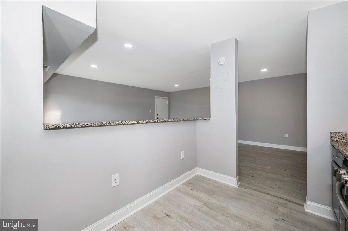 11368 Cherry Hill Road, Unit 1Q204 Beltsville, MD 20705 - Photo 12 of 46 an empty room with wooden floor and a bathroom