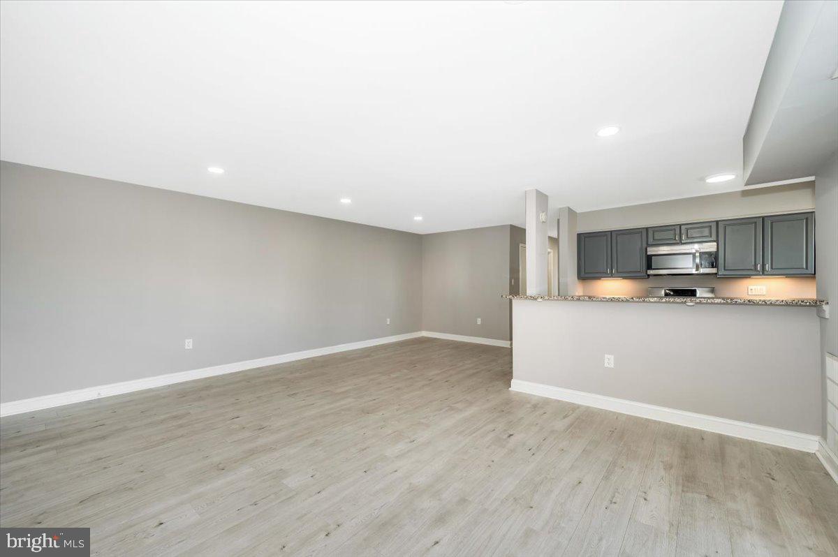 11368 Cherry Hill Road, Unit 1Q204 Beltsville, MD 20705 - Photo 13 of 46 a view of a kitchen with a sink wooden floor and a window