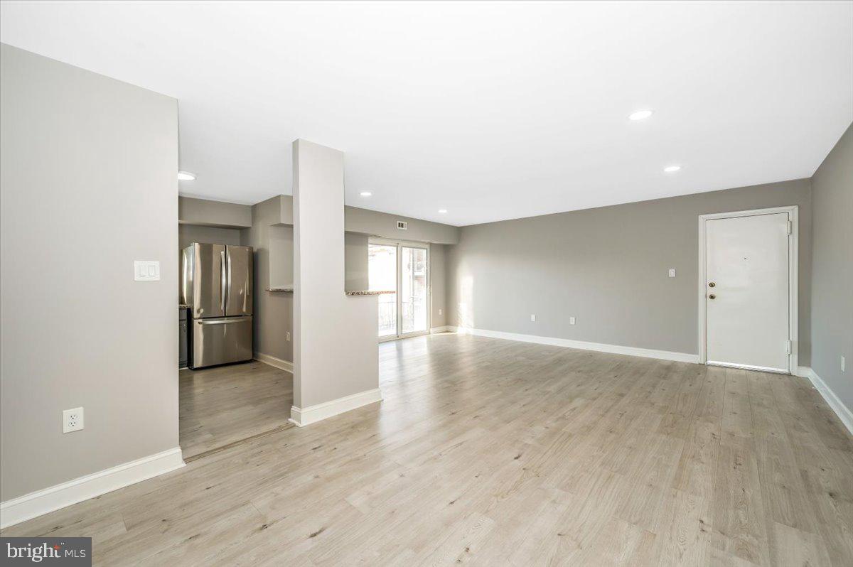 11368 Cherry Hill Road, Unit 1Q204 Beltsville, MD 20705 - Photo 15 of 46 a view of a livingroom with wooden floor and kitchen
