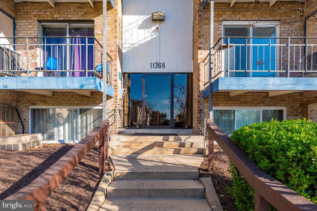 11368 Cherry Hill Road, Unit 1Q204 Beltsville, MD 20705 - Photo 2 of 46 a view of a house with a balcony and front door