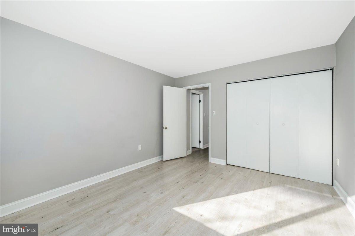 11368 Cherry Hill Road, Unit 1Q204 Beltsville, MD 20705 - Photo 24 of 46 an empty room with wooden floor
