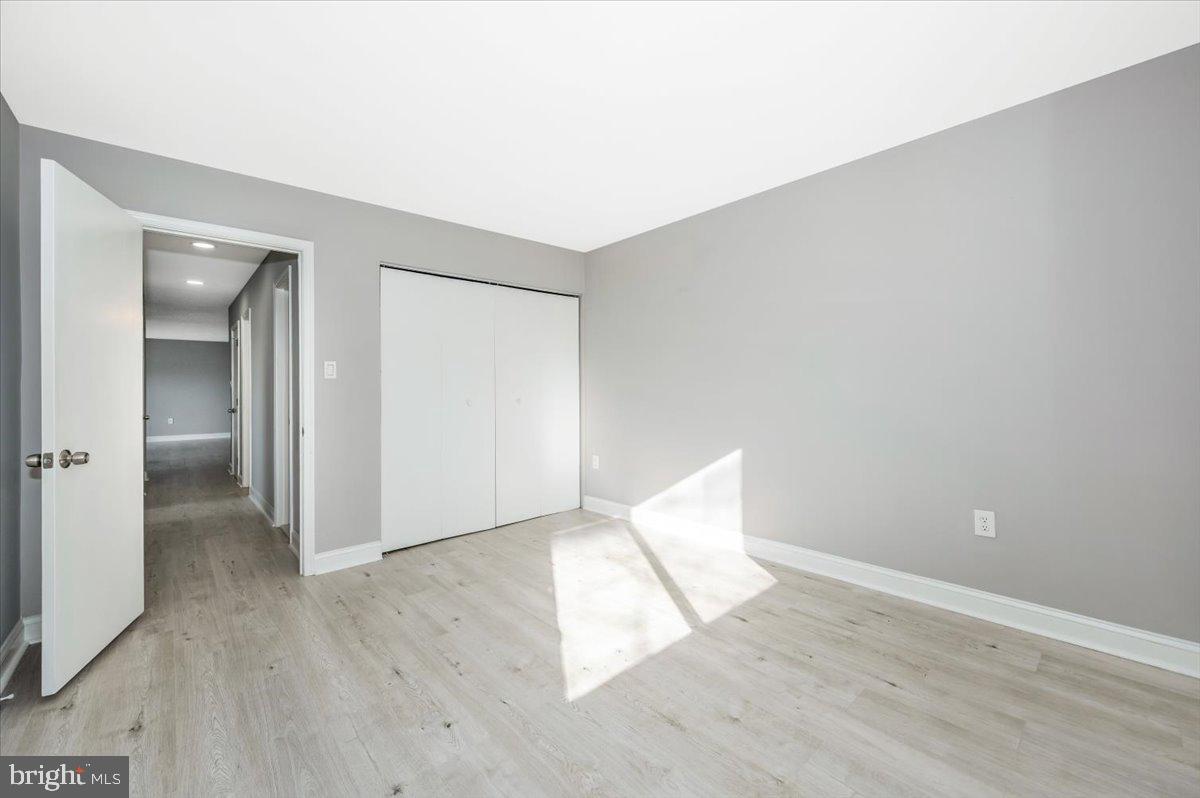 11368 Cherry Hill Road, Unit 1Q204 Beltsville, MD 20705 - Photo 25 of 46 an empty room with wooden floor and windows