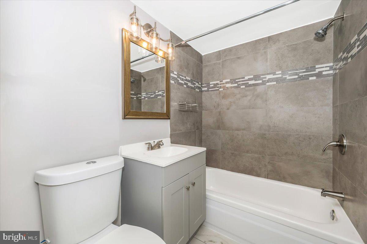 11368 Cherry Hill Road, Unit 1Q204 Beltsville, MD 20705 - Photo 26 of 46 a bathroom with a sink a toilet and shower