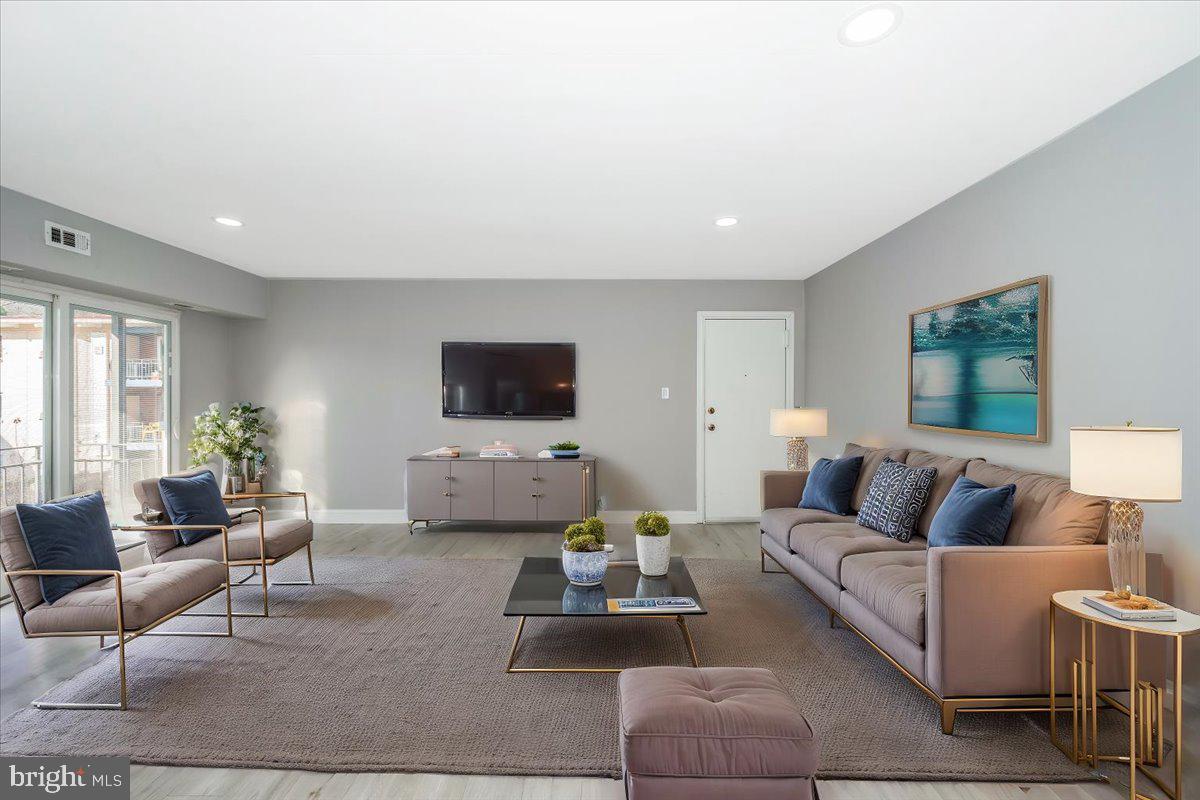 11368 Cherry Hill Road, Unit 1Q204 Beltsville, MD 20705 - Photo 3 of 46 a living room with furniture and a flat screen tv