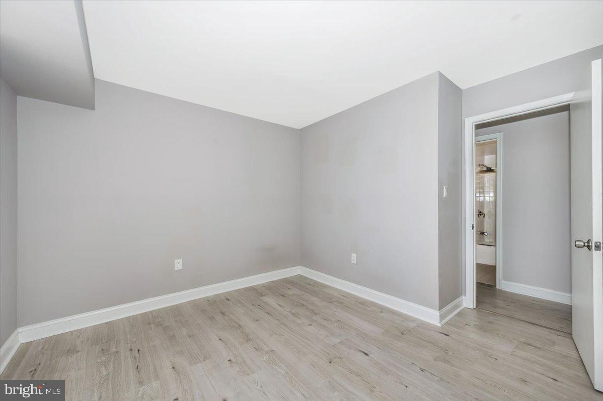 11368 Cherry Hill Road, Unit 1Q204 Beltsville, MD 20705 - Photo 31 of 46 a view of an empty room with wooden floor and closet