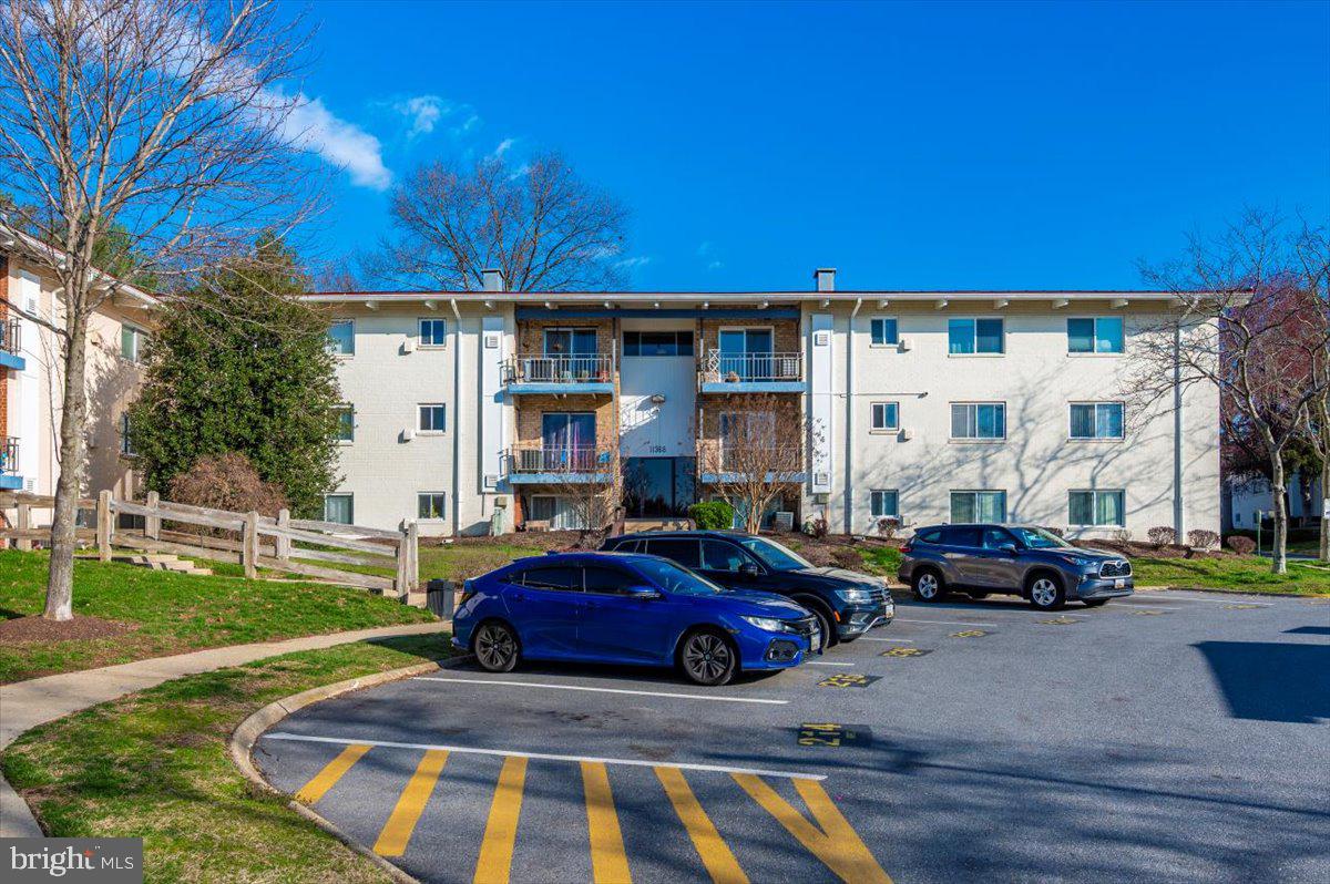11368 Cherry Hill Road, Unit 1Q204 Beltsville, MD 20705 - Photo 43 of 46 a view of a cars parked in front of a building